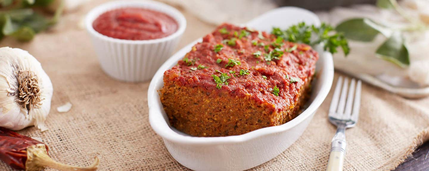 millet loaf in a white loaf-sized serving dish