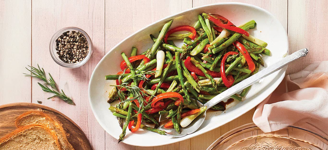 Roasted Asparagus with Tarragon and Balsamic on a white oval serving platter