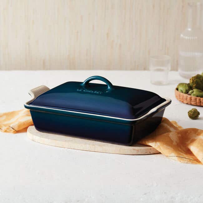 A Le Creuset rectangular baking dish with a lid in midnight navy blue