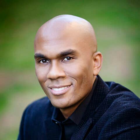 Headshot of Dr. Columbus Batiste against an out of focus green background