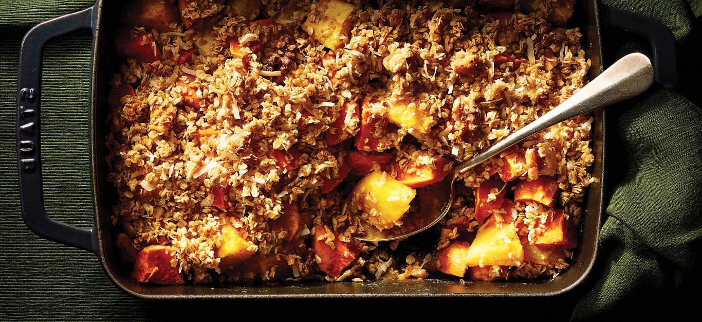 Sweet Potato and Pineapple Crisp in a rectangular cast iron dish against a dark green background