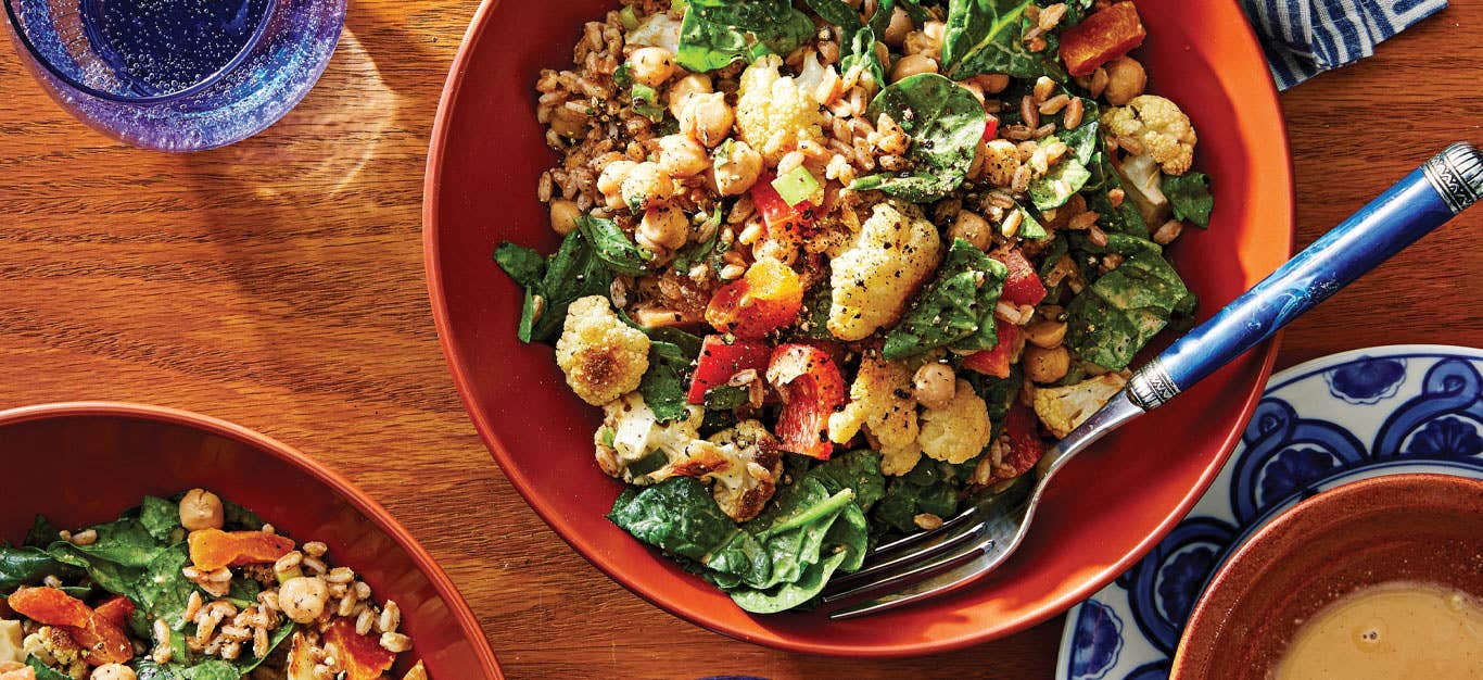 Moroccan Bean Salad in an orange bowl with a metal fork