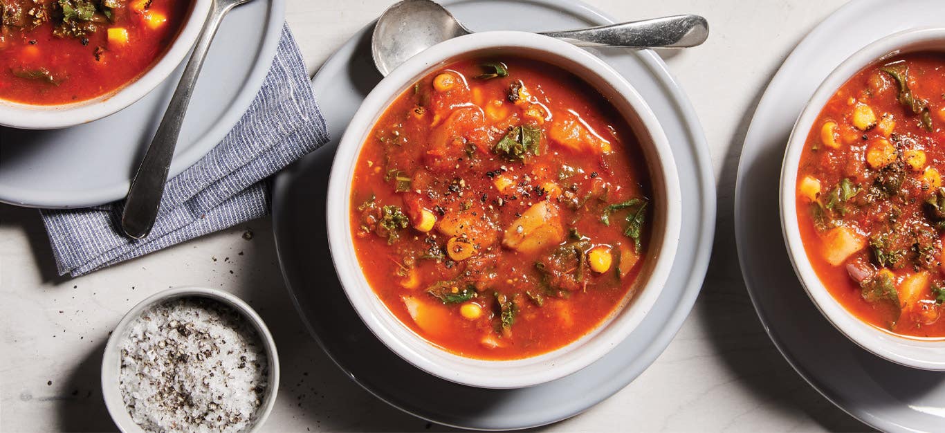 Roasted Vegetable Chowder in white ceramic bowls against a white tabletop