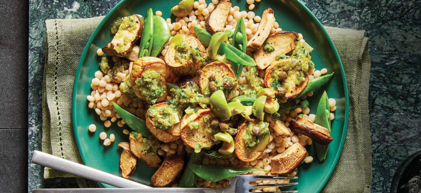 Vegan Mushroom Scallops with Spanish-Style Olive-Herb Sauce on a green plate sitting on a pale green cloth napkin