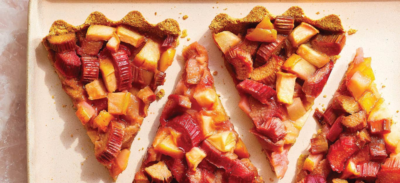 Four slices of Rhubarb and Pear Tart on a large rectangle cream plate, placed with space between each slice