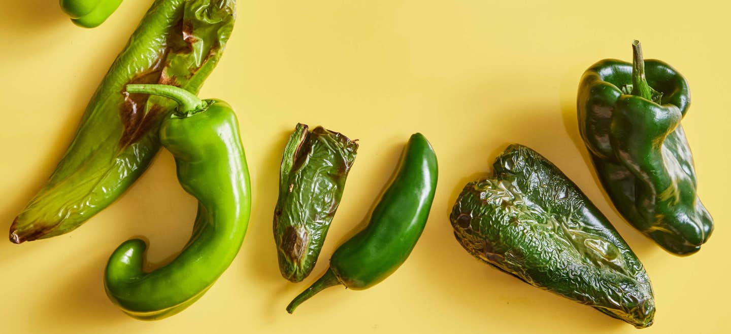 a few air-fryer roasted chile peppers shown on a yellow background