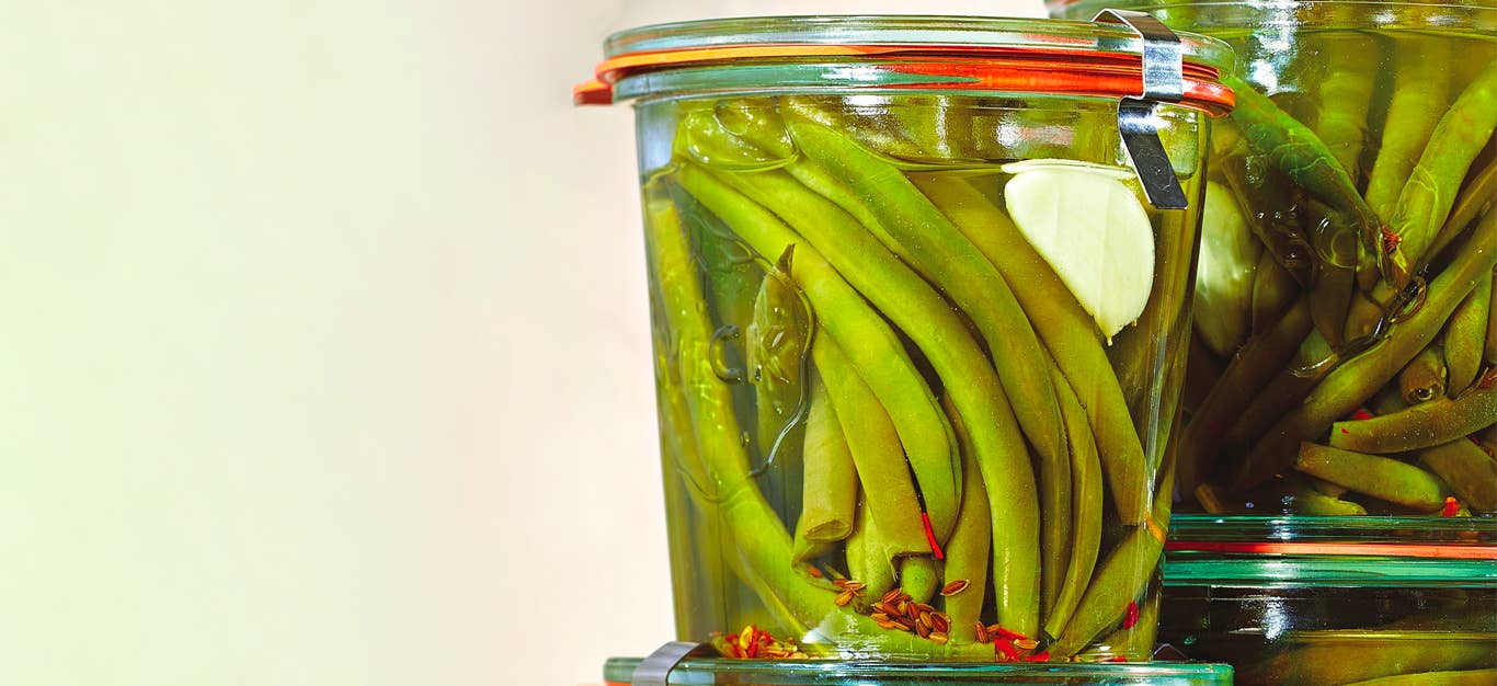 A couple of air-tight jars of Spicy Pickled Green Beans stacked on top of each other
