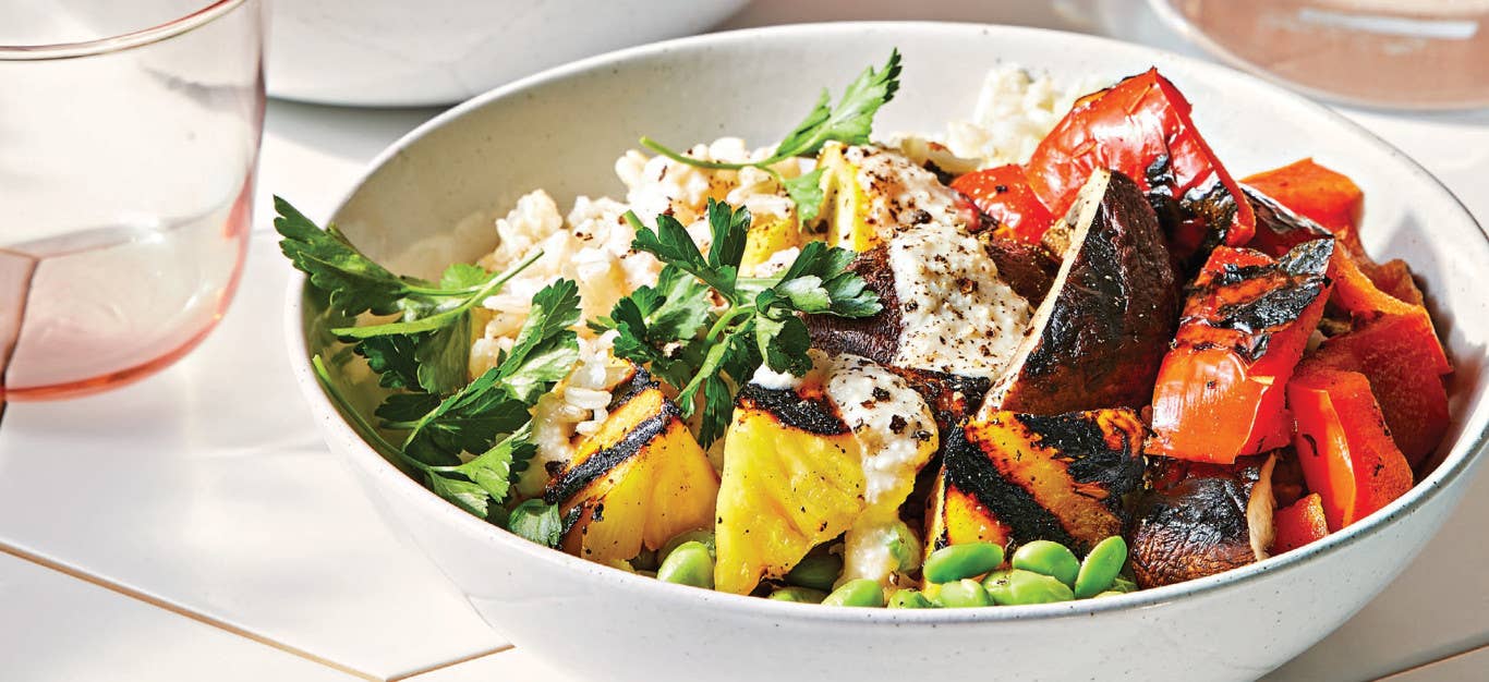 Grilled Pineapple Veggie Bowls with Spicy Cashew Crema in a white pasta bowl