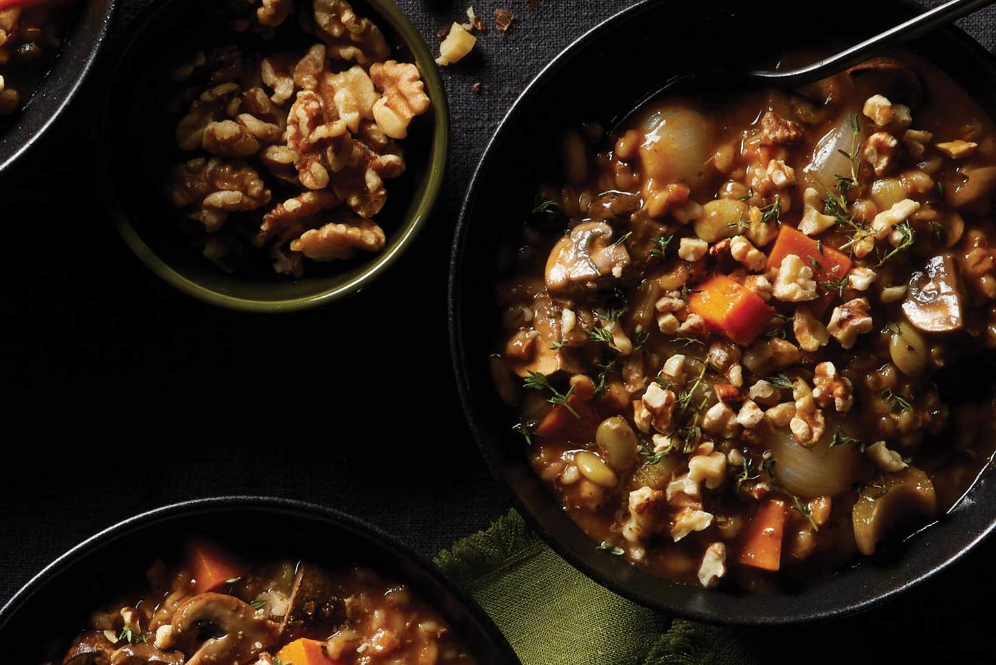 an Instant Pot full of mushroom and barley stew, beside two bowls of mushroom and barley stew