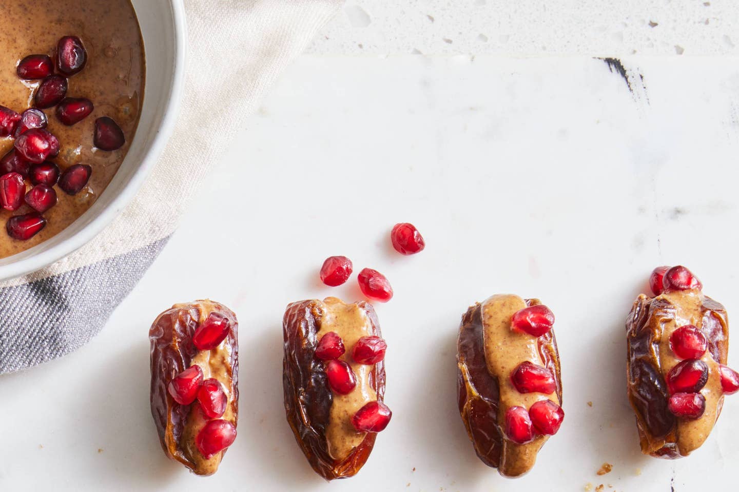 Medjool dates stuffed with nut butter and sprinkled with pomegranate arils