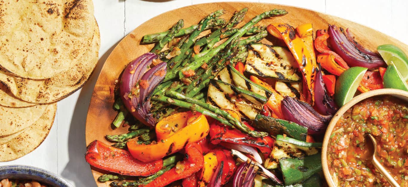 Grilled Fajita Platter on a large wooden platter with a bowl of Smoky Tomato Salsa