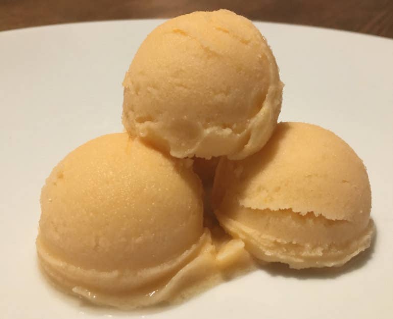 Three scoops of cantaloupe ice cream made in the Ninja Creami