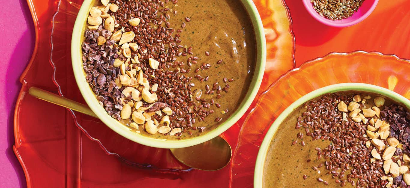 Two Chocolate Peanut Butter Smoothie Bowls on a bright orange platter against a hot pink background