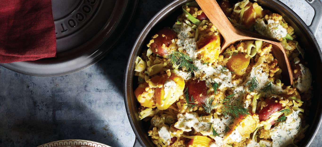 Kasha Pot with Potatoes, Cabbage, and Golden Beets in a skillet with a wooden spoon