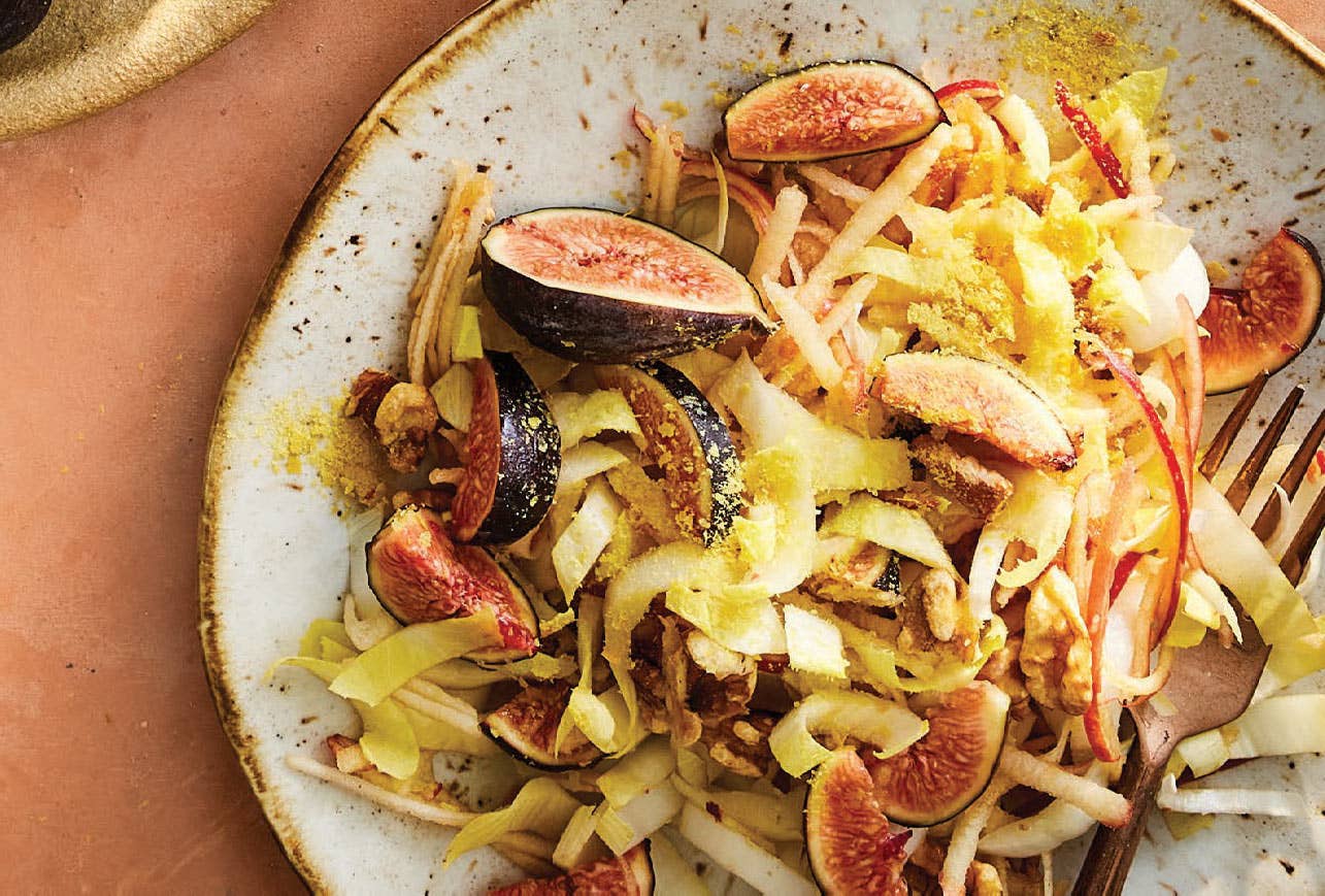 A salad made with fresh figs and endive and shredded apple, drizzled with balsamic