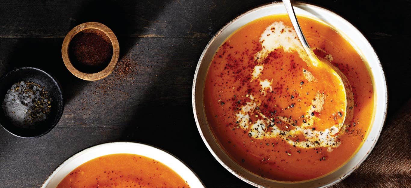 Chipotle Butternut Squash Soup in a white bowl with a serving spoon