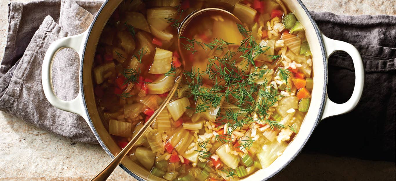 A white pot with handles full of Vegan Chicken and Rice Soup