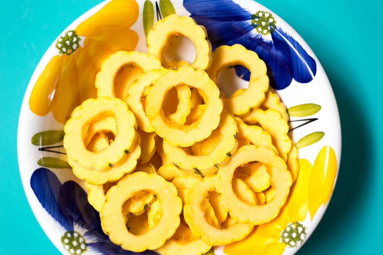 a bowl of delicata squash cut into rings