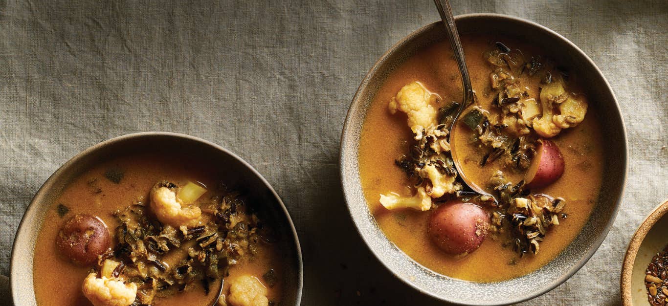 Two bowls of Chipotle-Potato Wild Rice Soup on a natural brown tablecloth