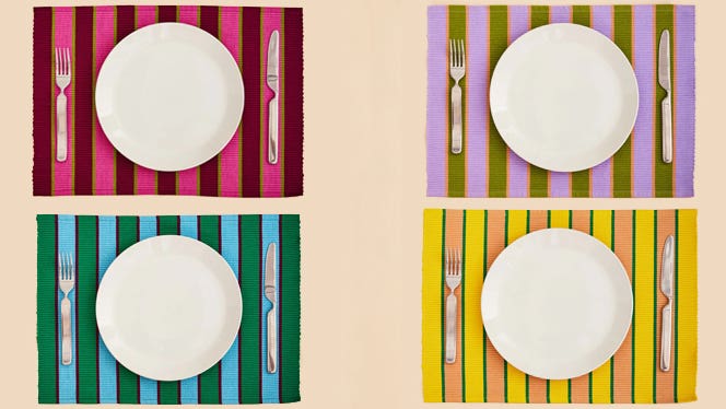 Set of four Herb Stripe Place Mats by Dusen Dusen, each placemat topped with a plain white plate and fork and knife