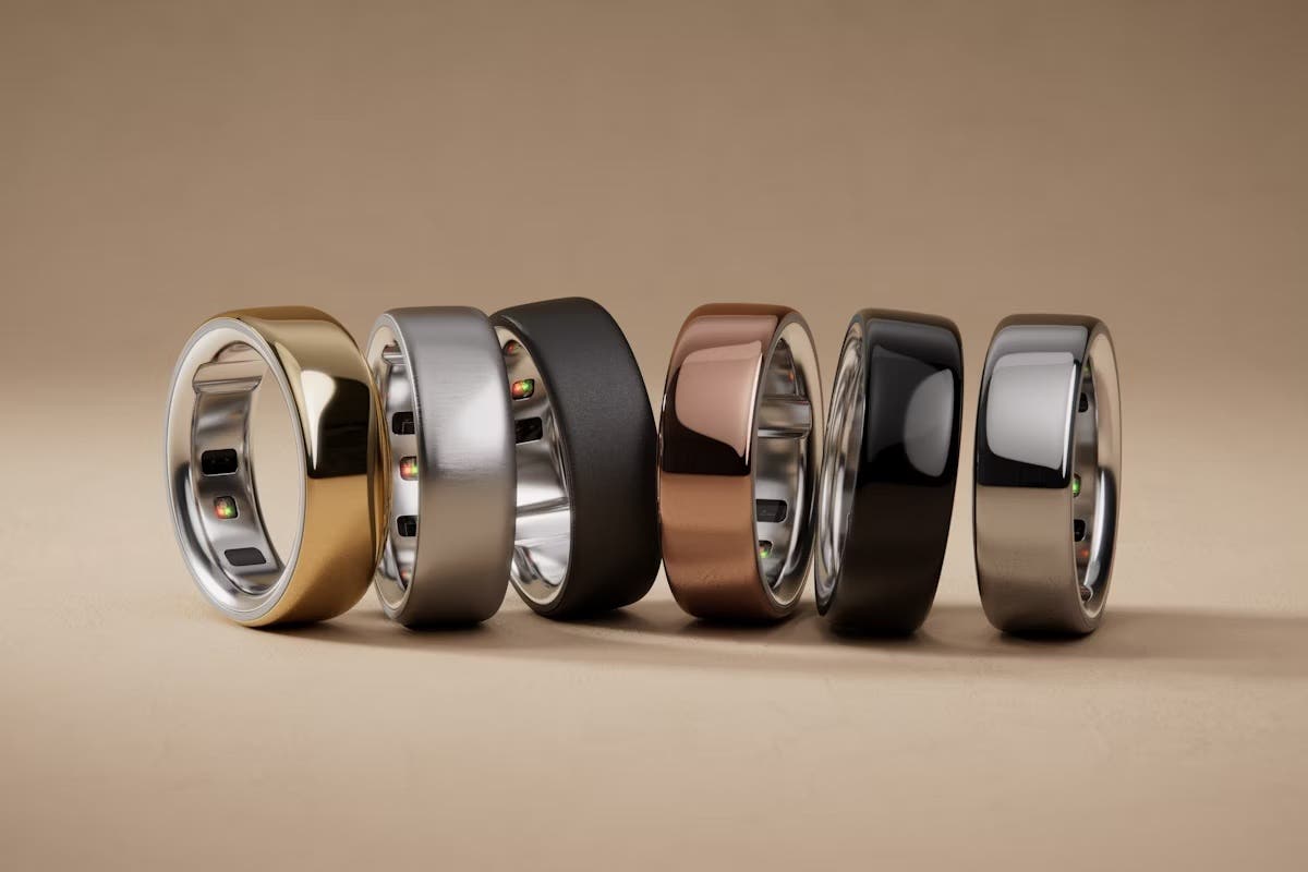 Oura health-tracking rings in a range of colors, stacked next to each other on their sides