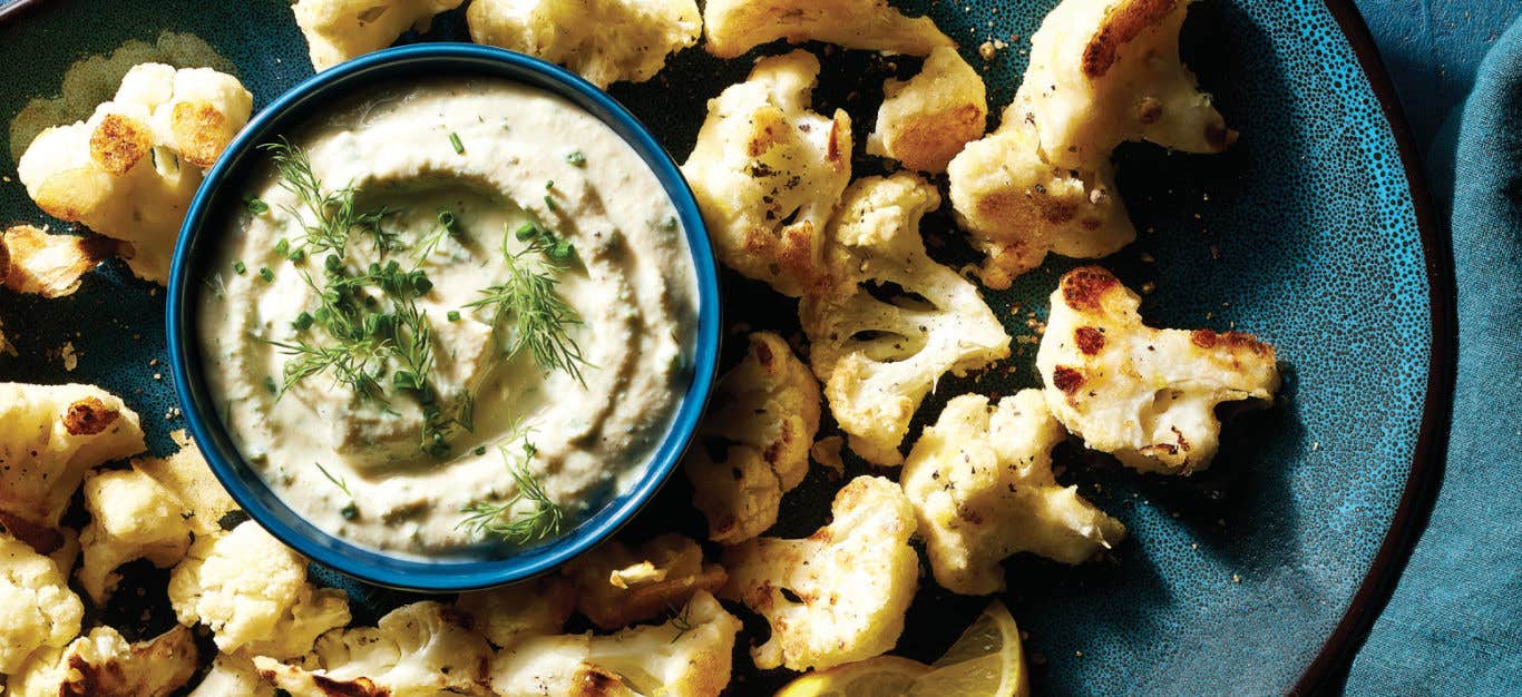 Crispy Cauliflower Bites on a platter with a small bowl of Ranch Dip in the middle