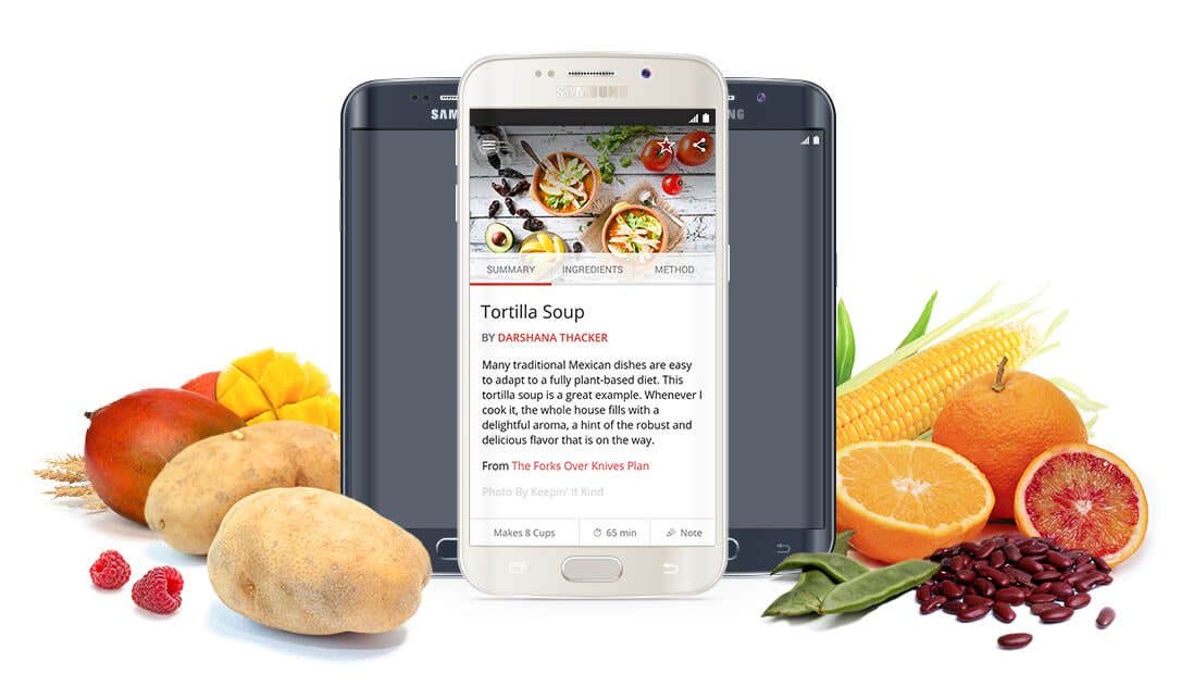 Mobile android phone displaying the Forks Over Knives recipe app, with fresh fruits and veggies to the side