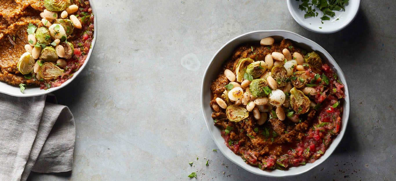 Baked Mushroom Polenta Bowls with white beans and brussels sprouts n a gray countertop