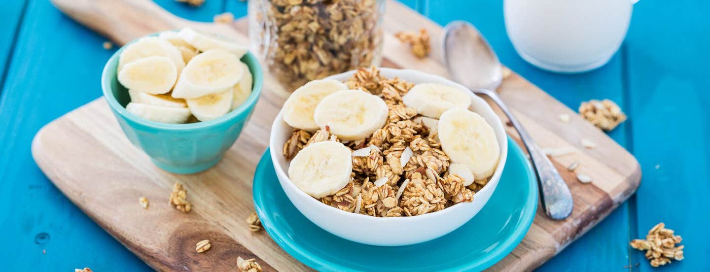 vegan granola sweetened with bananas in a white bowl on a blue plate