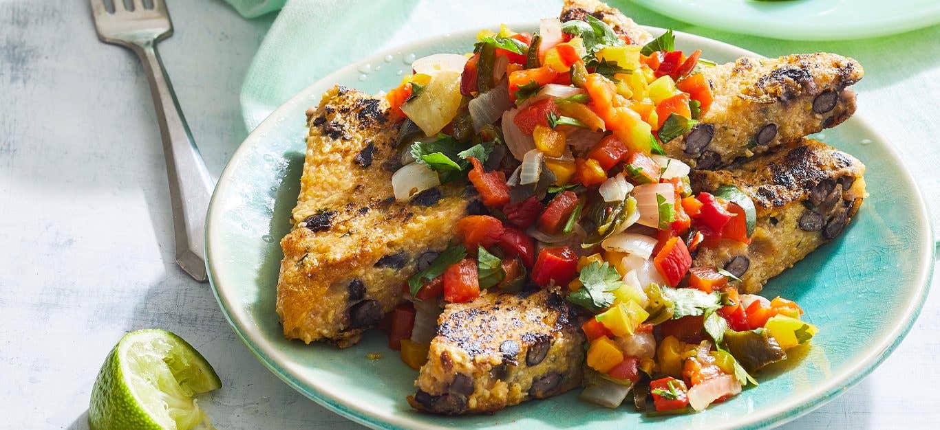 Black Bean Polenta Cakes with Pepper-Cilantro Salsa on a green plate