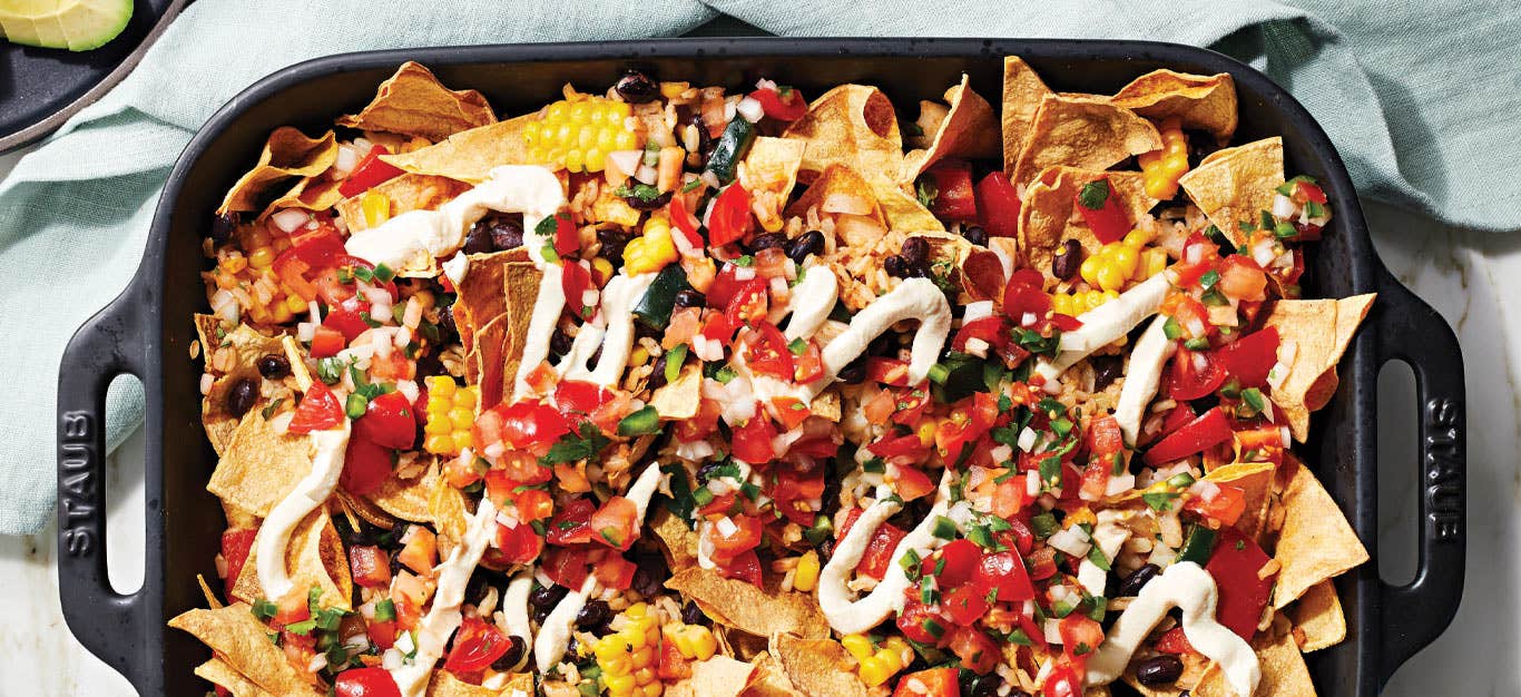 Healthy Breakfast Nachos with Vegan Sour Cream in a cast iron casserole dish