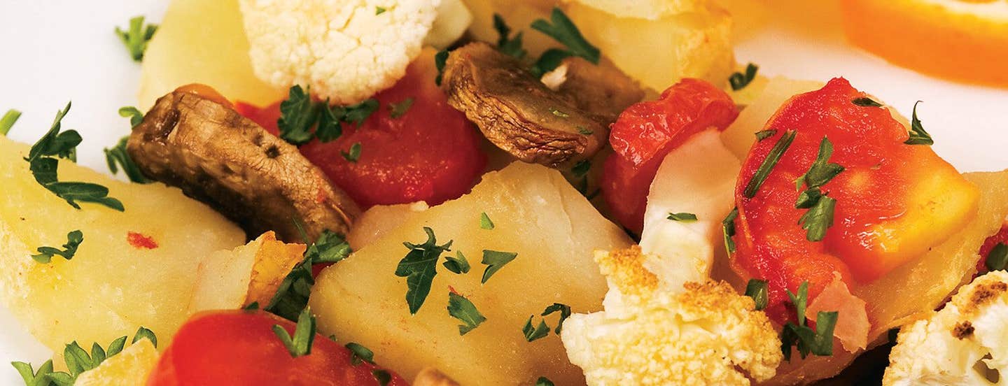 A closeup photo of Breakfast Potatoes showing chunks of mushroom, potato, cauliflower, and tomato