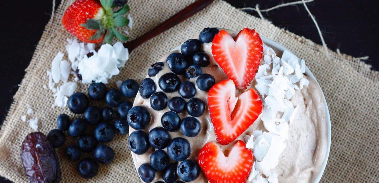 2-Ingredient Chocolate Banana Ice Cream garnished with sliced strawberries, blueberries, and coconut shreds