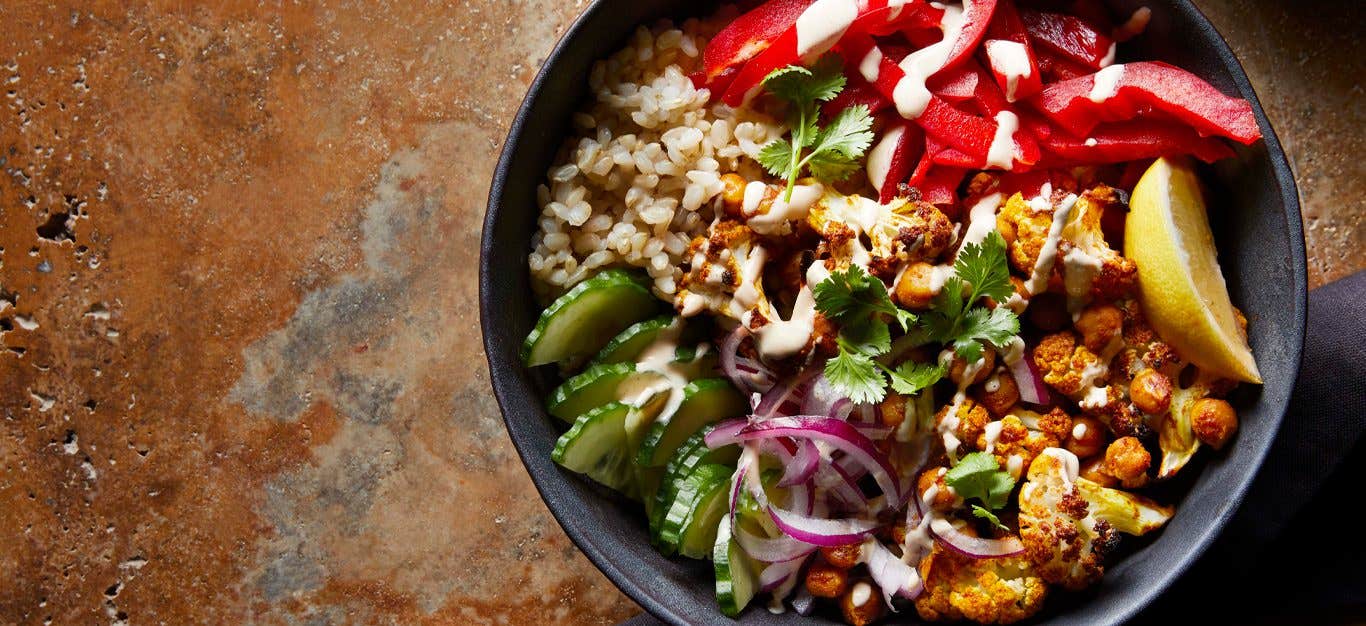 Vegan Shawarma with Roasted Cauliflower and Chickpeas in a gray bowl on stone counter