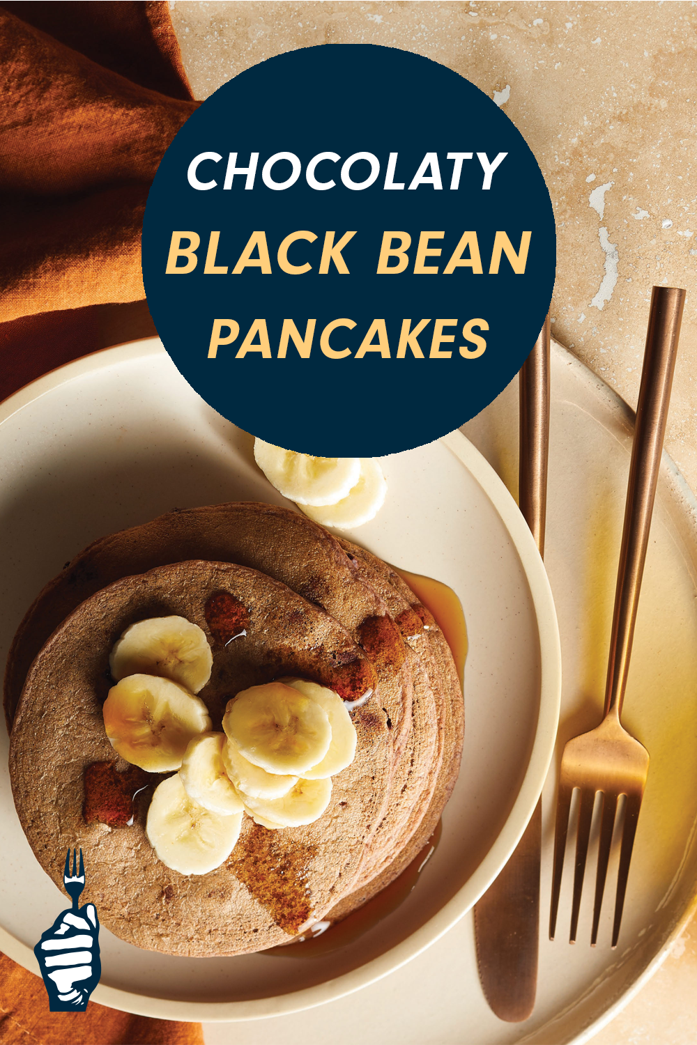 A plate of pancakes topped with scliced banana and ample syrup with a knife and fork to the side. Text reads, "Chocolaty Black Bean Pancakes"