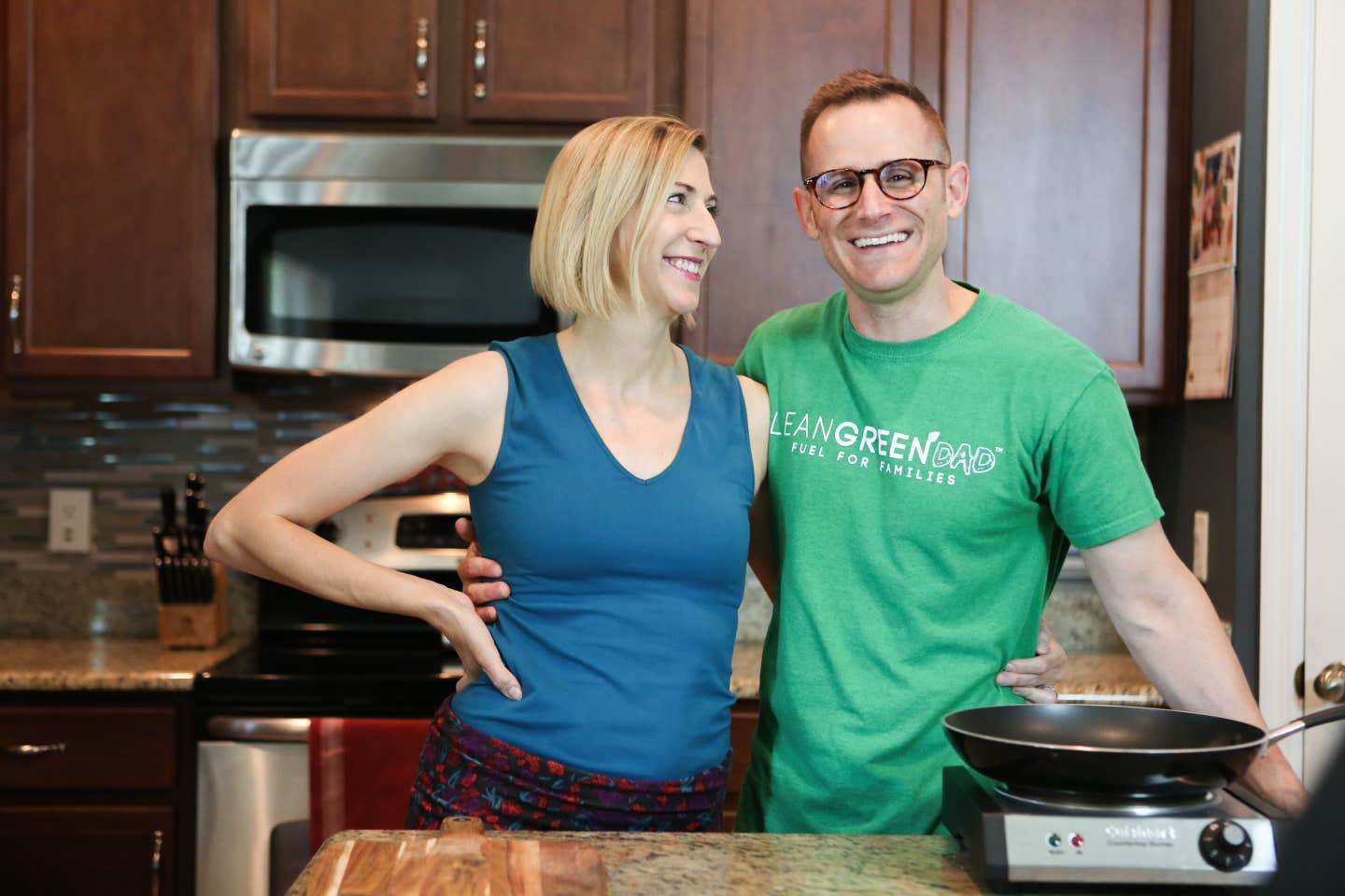 Cory and Jenn Warren arm in arm in their kitchen