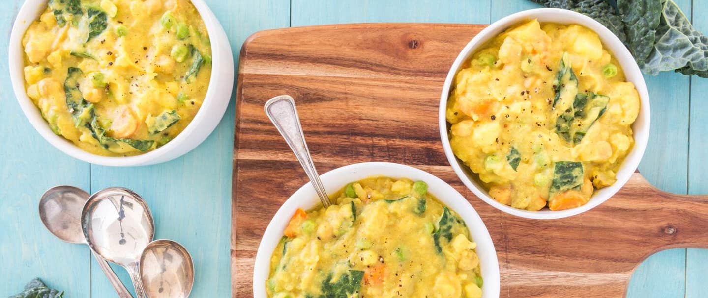 Three bowls of Creamy Potato Curry with a chopping board