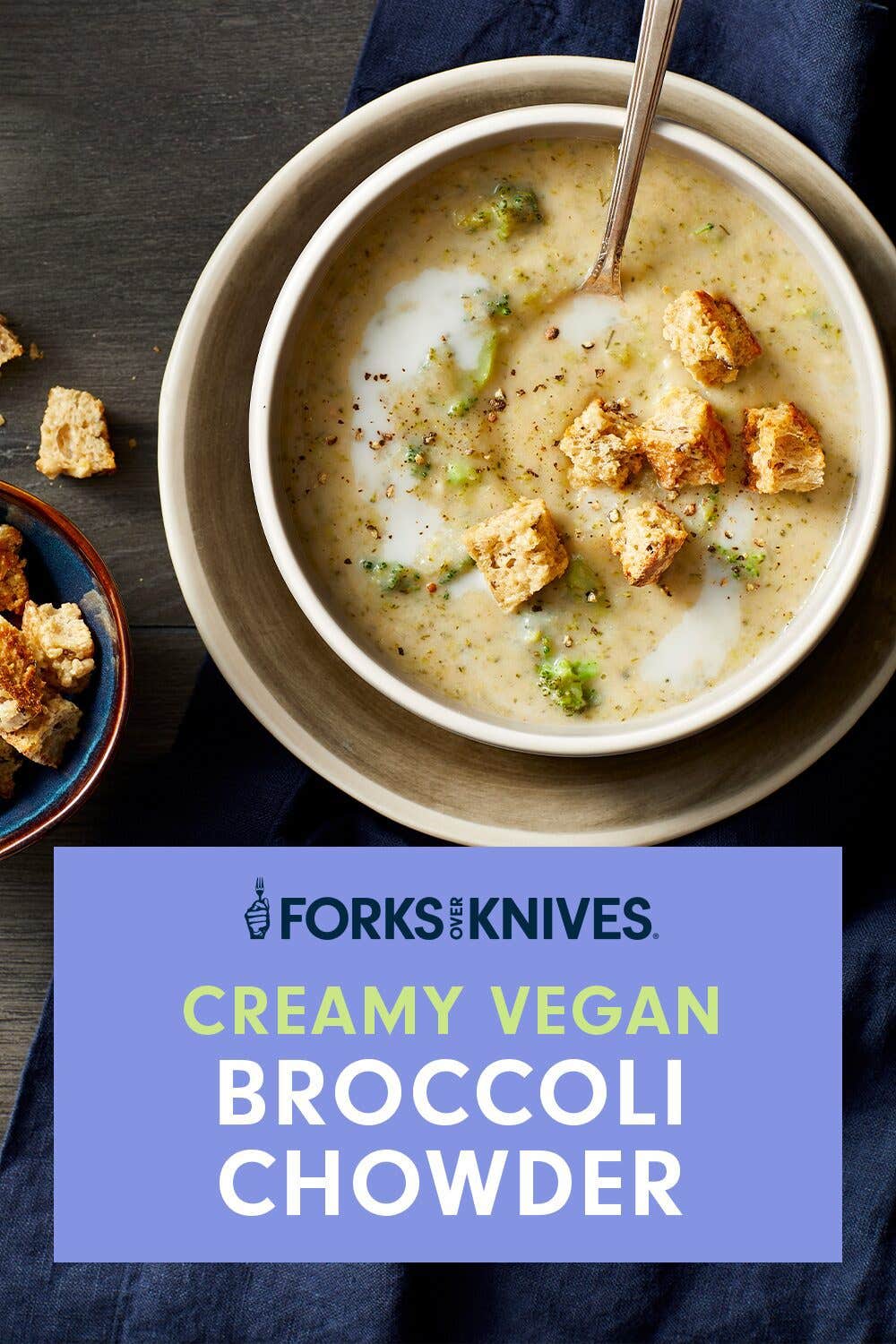 Creamy Vegan Broccoli Chowder in a cream bowl nested on a plate of the same color, garnished with crispy croutons