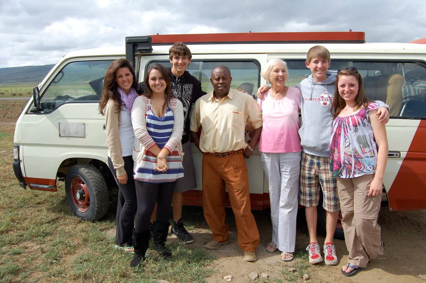 80-year old Beverly Kelly standing with her famliy in front of a van