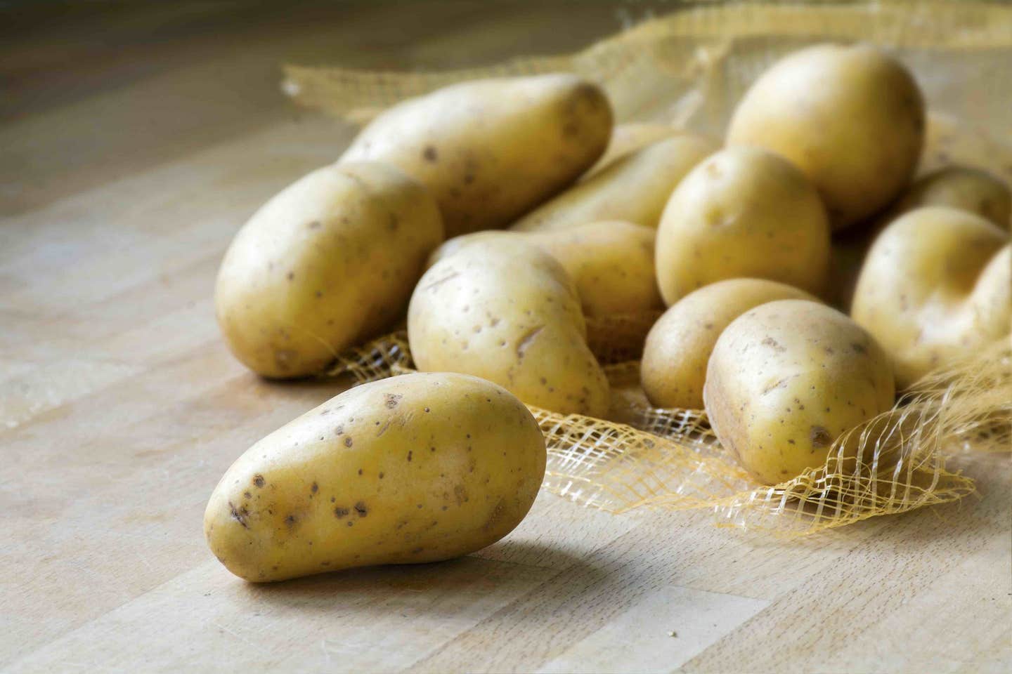 new organic potatoes on a wooden kitchen board