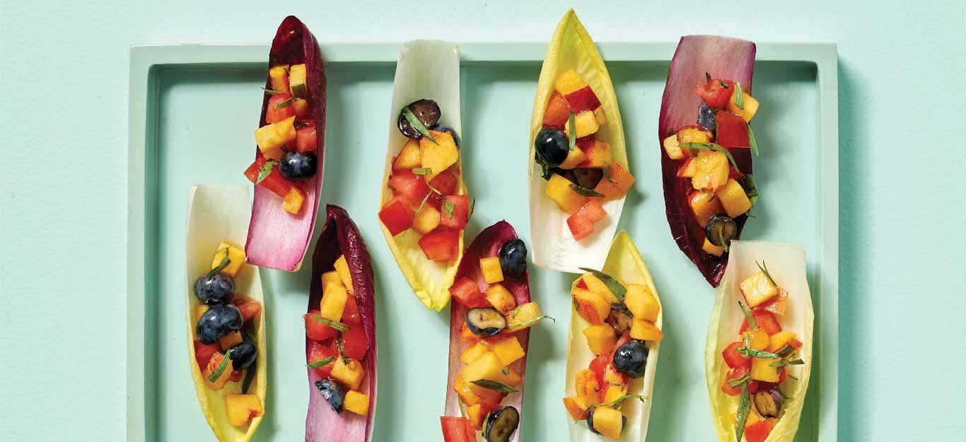 Endive Boats with Summer Fruit on a light blue platter