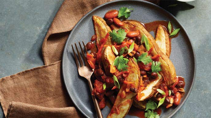 Easy Chili Fries on a gray plate with a brown cloth napkin