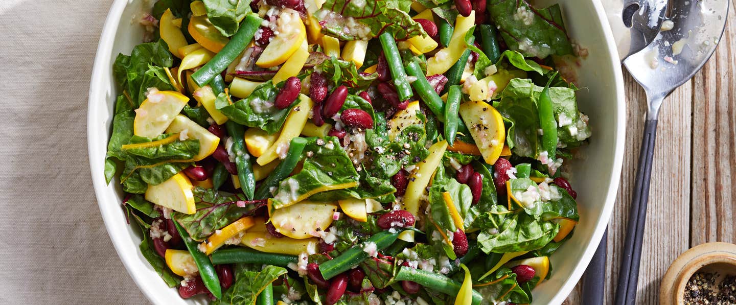 A serving of salad, with green beans, summer squash, chard, and kidney beans