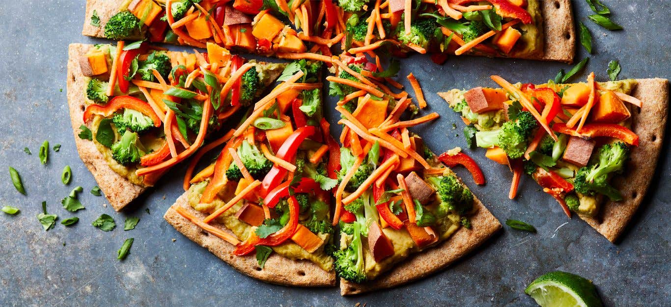 Green Curry Thai Pizza on a concrete countertop