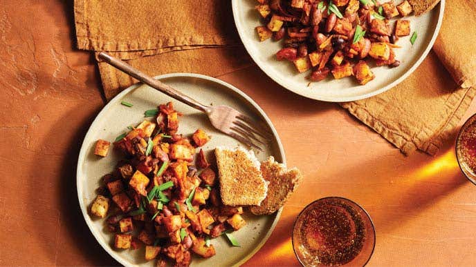 Oven-Roasted Breakfast Hash on gray ceramic plates on an orange tabletop