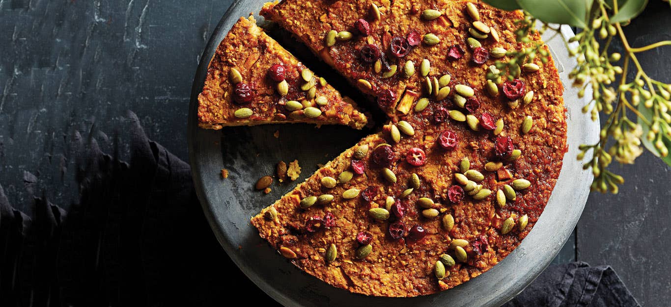 Vegan Holiday Dinner Torte on a gray cake stand against a slate countertop