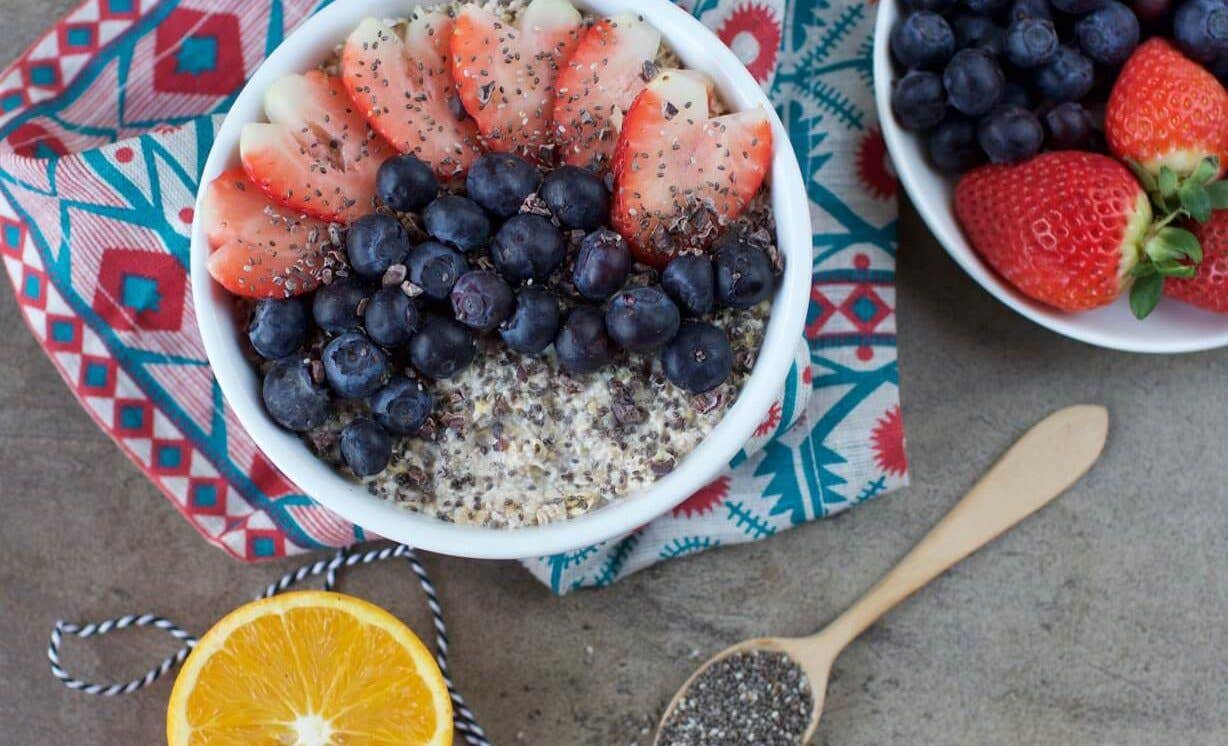 A bowl of oats with blueberries and strawberries