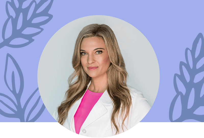 Headshot of Dr. Kristi Funk in a white lab coat with a pink t-shirt