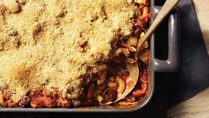 Baked Chili Mac in a rectangular dish with a metal serving spoon