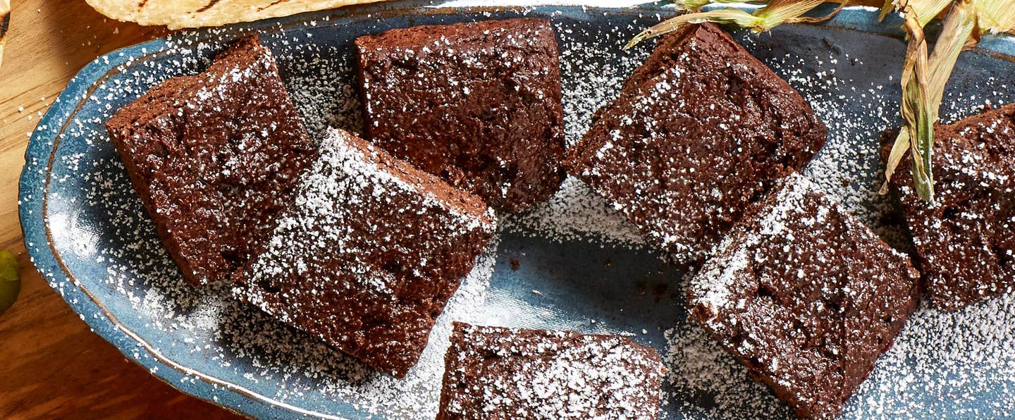 Mexican Chocolate Brownies on a plate, dusted with a light coating of powdered sugar